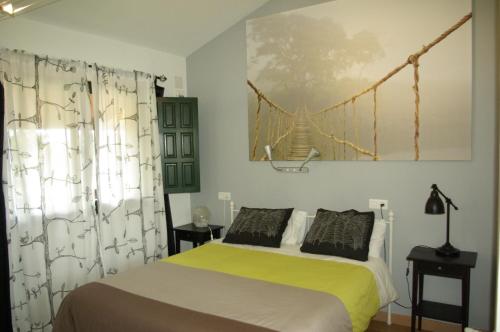 a bedroom with a bed with a yellow and white blanket at Aldea del Trasgu in Cuerres