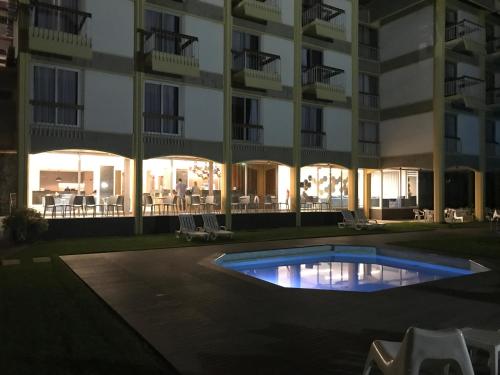 an empty pool in front of a building at night at Hotel do Parque in Viana do Castelo