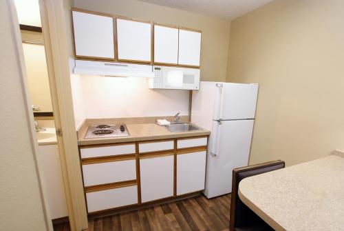 a small kitchen with a refrigerator and a sink at Extended Stay America Suites - Portland - Tigard in Tigard