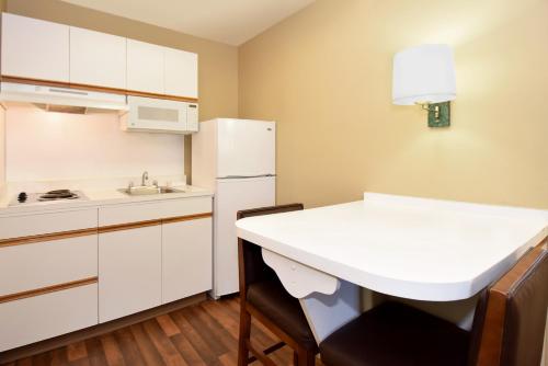 a kitchen with a white refrigerator and a sink at Extended Stay America Suites - Portland - Tigard in Tigard