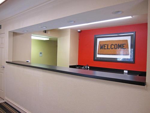 a waiting room with a welcome sign on a wall at Extended Stay America Suites - Portland - Tigard in Tigard
