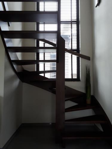 a spiral staircase in a room with a window at Willa nad morzem in Pobierowo