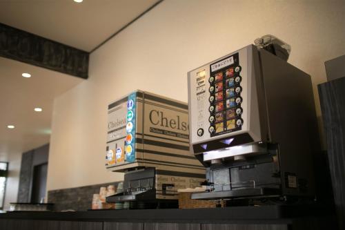 a cash register in a grocery store with a sign on it at Miyakonojo Green Hotel in Miyakonozyō