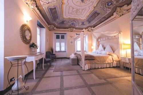 a bedroom with a large bed with a ceiling at Il Sogno Maison de Charme in Chiavari