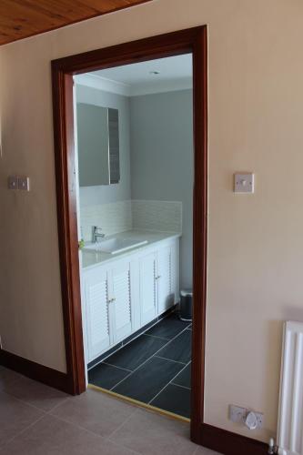 a bathroom with a sink and a mirror at Stow House in Berwick-Upon-Tweed