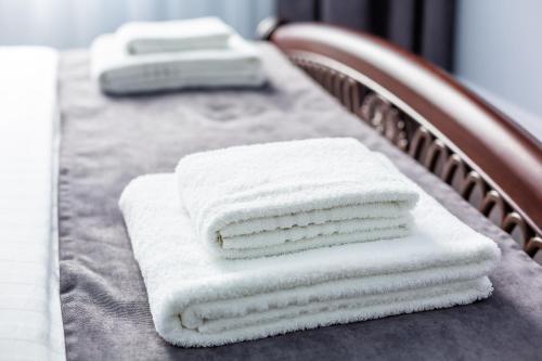 three towels are stacked on a table at ASAO-Apartments walking center zone in Lviv