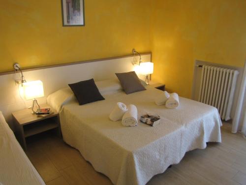 ein Hotelzimmer mit einem Bett mit Handtüchern darauf in der Unterkunft Madonna Dell'Aiuto True View Olivo in Brenzone sul Garda