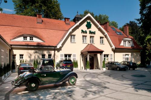 an old car parked in front of a building at Park Hotel in Szczecin