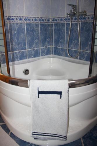 a bathroom with a bath tub with a towel on it at Guesthouse Relax and Fly Sarajevo in Sarajevo