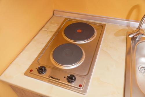 a stove top on a counter in a room at Amfora in Palić