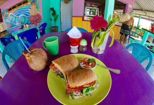 a purple table with a sandwich on a plate at Cafe de la Suerte in Pavones