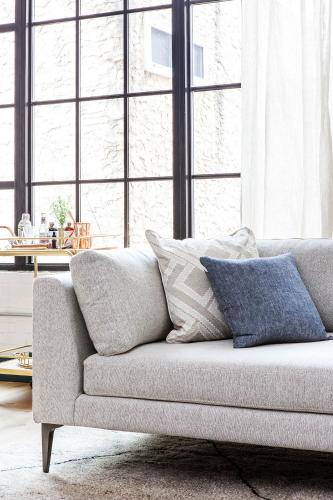 a couch with pillows on it in a living room at Lokal Hotel Old City in Philadelphia