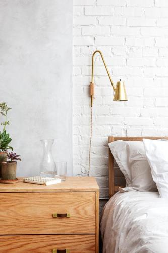 a bedroom with a bed and a lamp on a dresser at Lokal Hotel Old City in Philadelphia