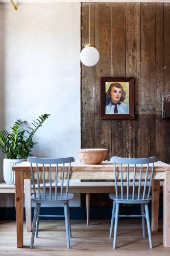 a dining room with a wooden table and two chairs at Lokal Hotel Old City in Philadelphia