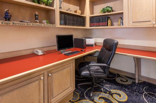 an office with a desk with a computer and a chair at Affordable Suites of America Detroit-Warren in Warren