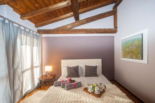 a bedroom with a bed with a large window at The Terrace on the Lake in Marone