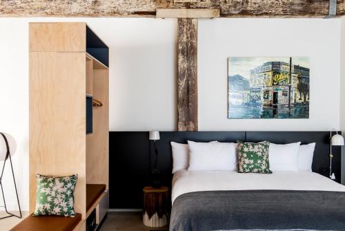 a bedroom with a bed with a black headboard at Veriu Broadway in Sydney