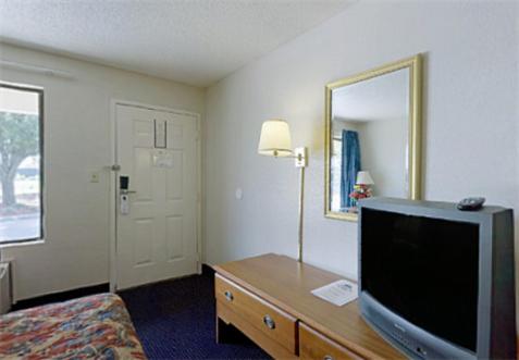 a hotel room with a flat screen tv in a room at Americas Best Value Inn & Suites in Murfreesboro in Murfreesboro