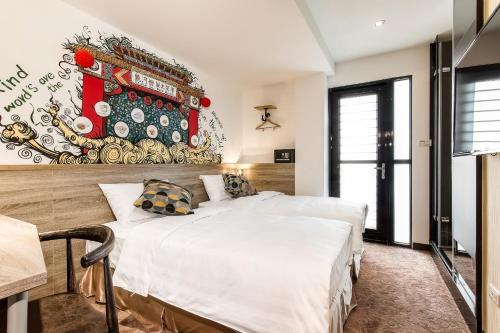 a bedroom with a large white bed and a mural at RF Hotel  Linsen in Taipei