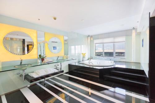 a large bathroom with a tub and a sink at Regal Airport Hotel in Hong Kong