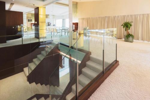 a glass stair case in a lobby with a staircase at Regal Airport Hotel in Hong Kong