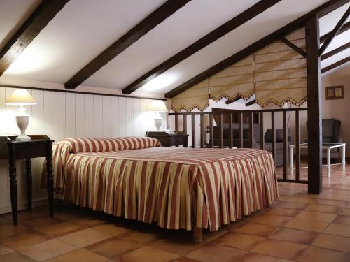 a bedroom with two beds and a table and chairs at Hotel Veracruz in Utrera
