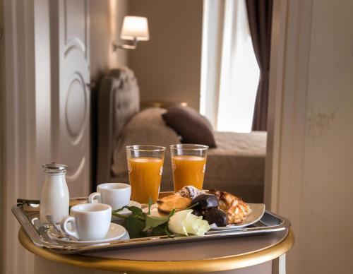 a tray with breakfast foods and drinks on a table at Palazzo Bove in Galatone