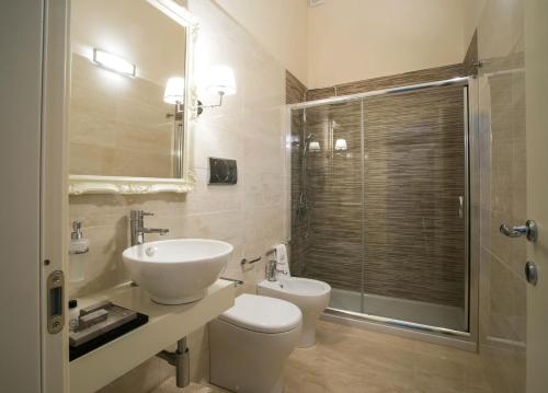 a bathroom with a toilet and a sink and a shower at Palazzo Bove in Galatone