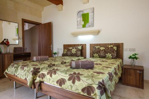 a bedroom with a large bed in a room at Carini Farmhouses in Għarb
