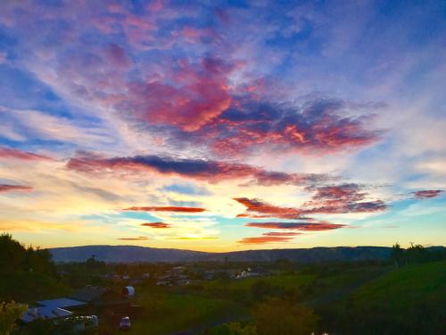 a sunset with colorful clouds in the sky at Hunters Moon in Mosgiel