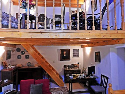 a living room with a wooden staircase with shoes on it at Chora View in Kýthira