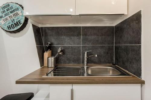 a kitchen with a sink and a counter top at CMG Montorgueil IV in Paris