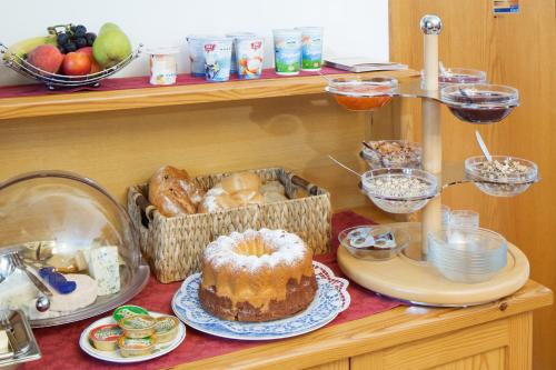 a shelf filled with different types of bread and desserts at Weingut und Gästehaus Salzl in Illmitz