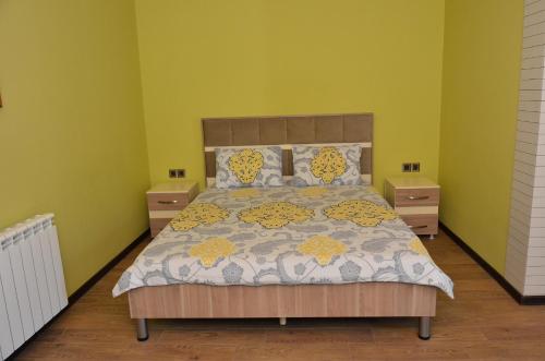 a bedroom with a large bed with two night stands at Sheki Panorama Guest House in Sheki