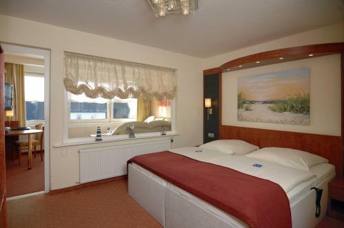 En eller flere senge i et værelse på Hotel Hansa