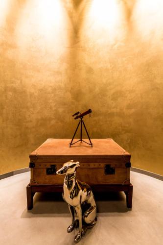 a statue of a dog sitting next to a suitcase at Hotel Resol Nagoya in Nagoya