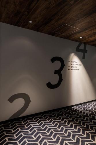 a wall with the number three on it at Hotel Resol Nagoya in Nagoya