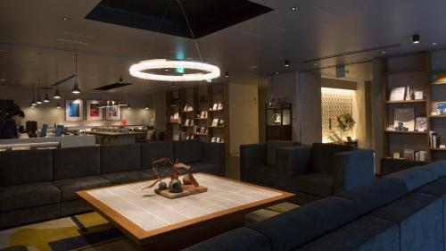a living room with a couch and a table at Hotel Resol Nagoya in Nagoya