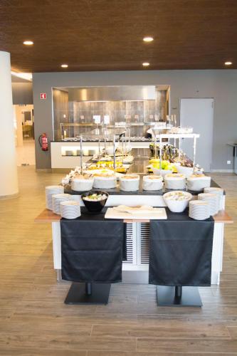 a buffet line with many bowls of food in a kitchen at AP Maria Nova Lounge - Adults Friendly in Tavira