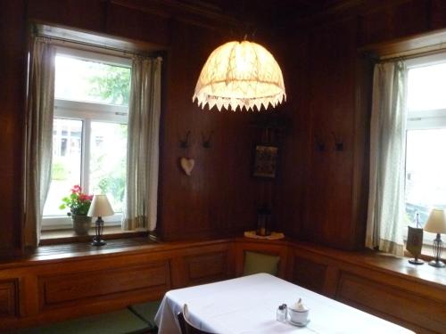 a dining room with a table and a chandelier at Apartment Grattschlössl in Sankt Johann in Tirol