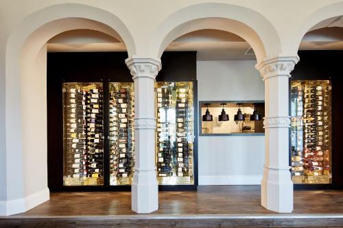 a display of wine bottles in a room with columns at Oddfellows On The Park in Cheadle