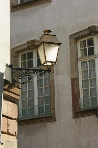 a street light on the side of a building with a window at Quai 17 Maison d'hôtes in Strasbourg