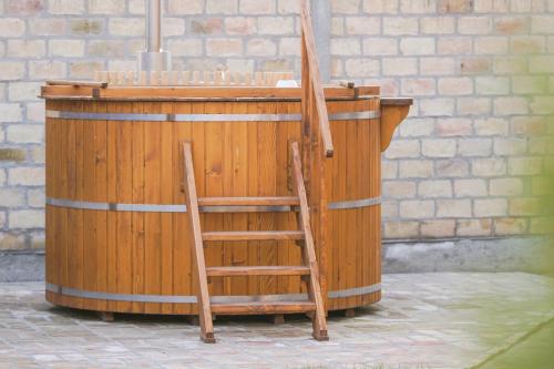 a wooden podium with a wooden chair in front of it at Amfora in Palić