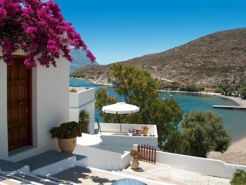 a view of a beach from a house with flowers at Villa Notos in Adamantas