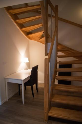 a desk and a chair next to a staircase at Chalet Taube in Bad Gastein