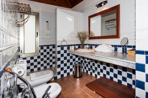 a bathroom with blue and white tiles and a sink at Casa Tagoro, facing the Ocean in Tacoronte