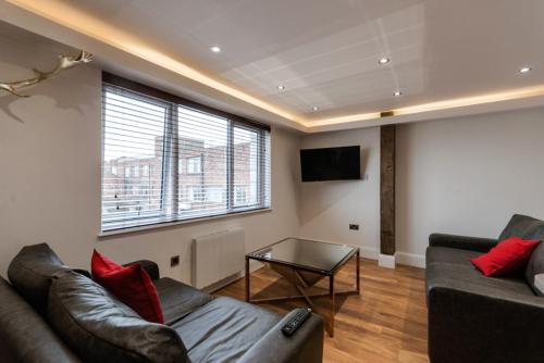 a living room with a couch and a table at The Picture House Apartments in Liverpool