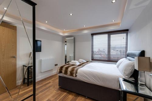 a bedroom with a large bed and a window at The Picture House Apartments in Liverpool