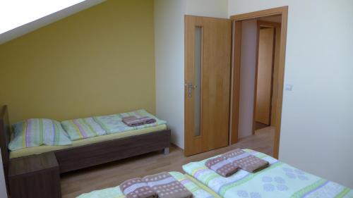 a bedroom with two beds and a staircase at Park - apartmány na prenájom in Nové Mesto nad Váhom