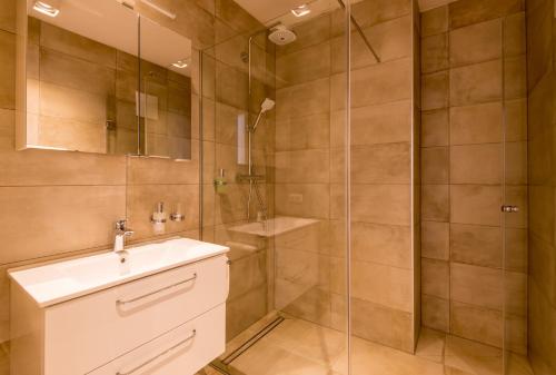 a bathroom with a sink and a shower at 24/7 Zimmer Asten in Asten